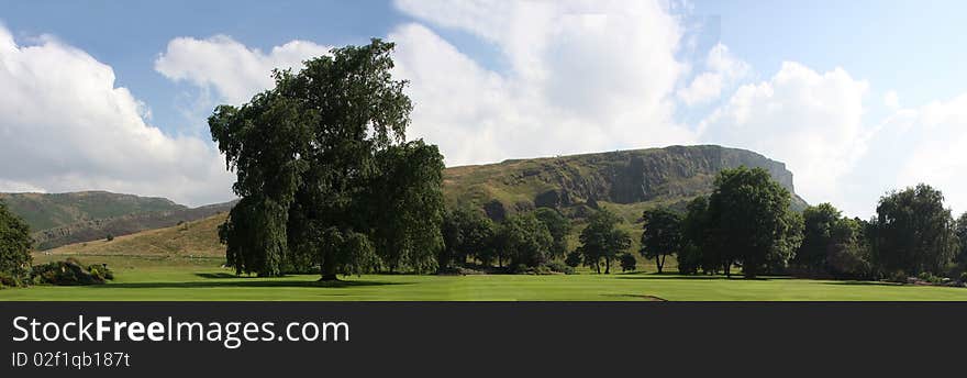 The Salisbury Crags is located in Holyrood Park (also called Queen's Park, and formerly King's Park) is a royal park in central Edinburgh, Scotland. It has an array of hills, lochs, glens, ridges, basalt cliffs, and patches of whin (gorse) within its 650-acre (260 ha) area. The park is associated with the royal palace of Holyroodhouse, and was formerly a 12th-century royal hunting estate.