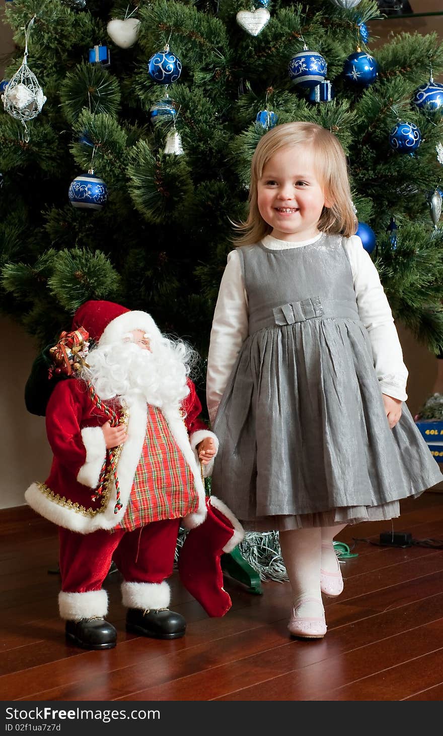 Cute little girl with toy Santa Claus