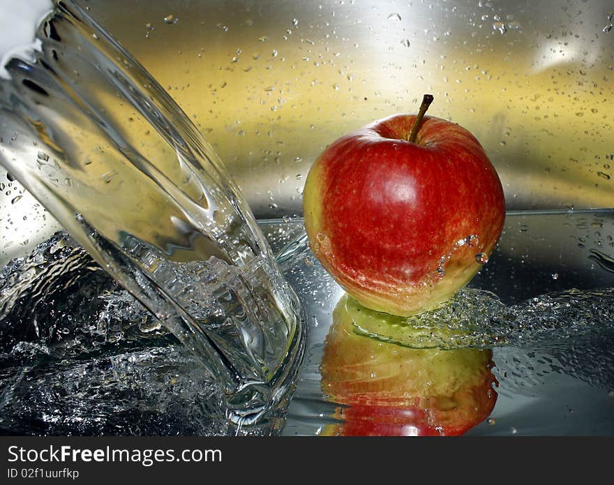 Water splashes and an apple