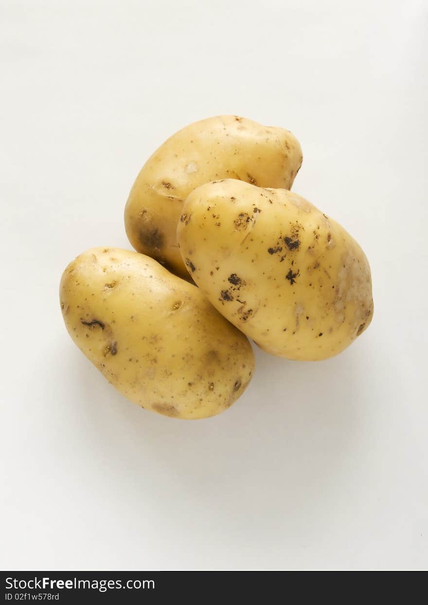 Three potatoes on a white background