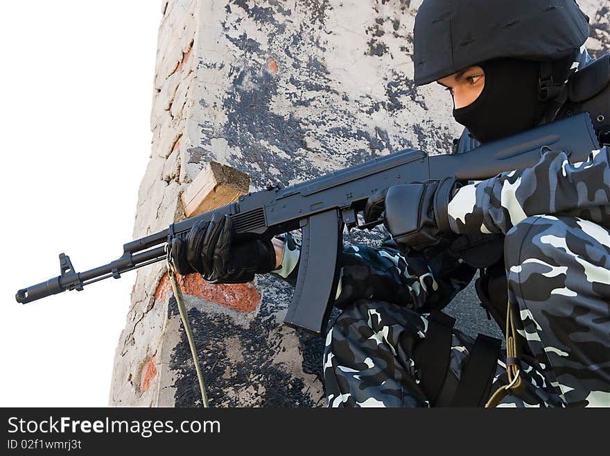 Officer in full ammunition targeting with automatic russian AK47 rifle. Officer in full ammunition targeting with automatic russian AK47 rifle