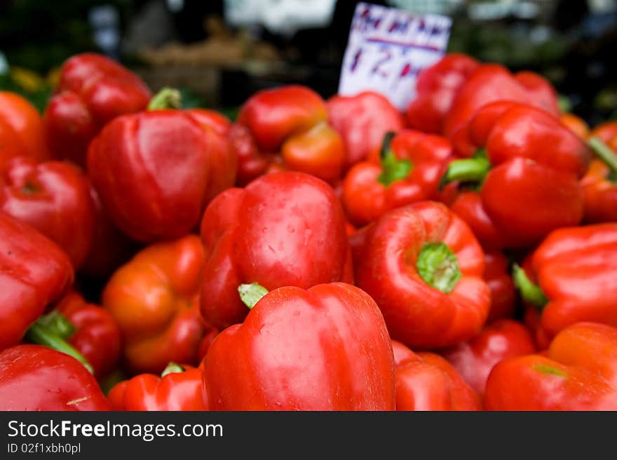 Fresh wet red peppers for sale at a farmer's market. Fresh wet red peppers for sale at a farmer's market.