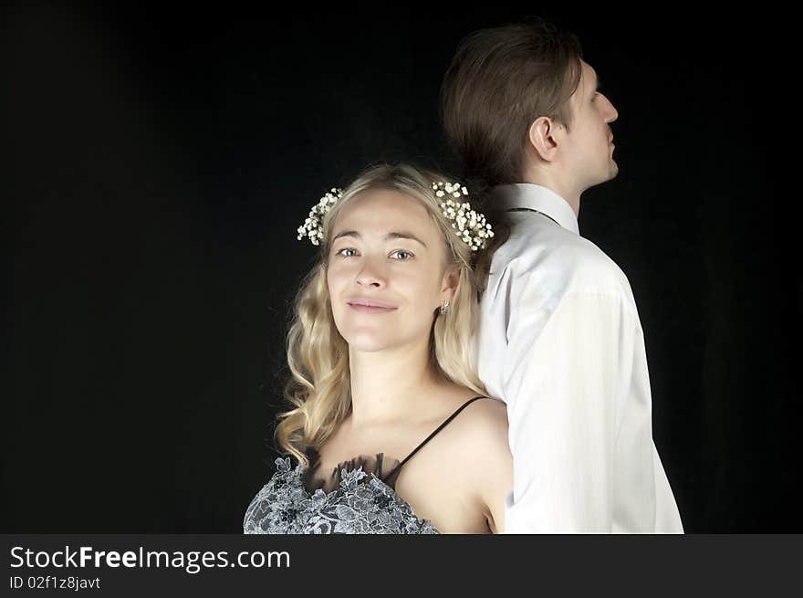 Happy bride and groom posing together in studio