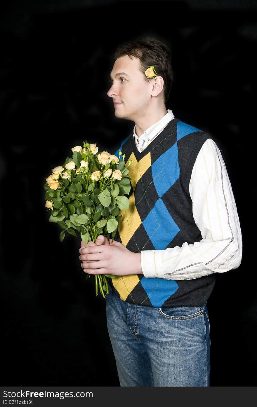 A young, attractive and happy man with flowers