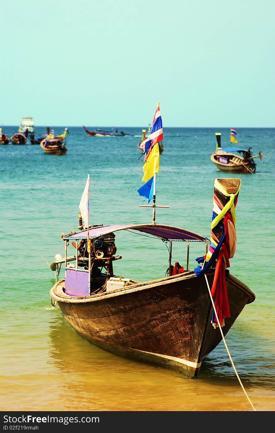 A longboat docked by the shore waiting for distant travelers to take it on another sea worthy adventure. A longboat docked by the shore waiting for distant travelers to take it on another sea worthy adventure.