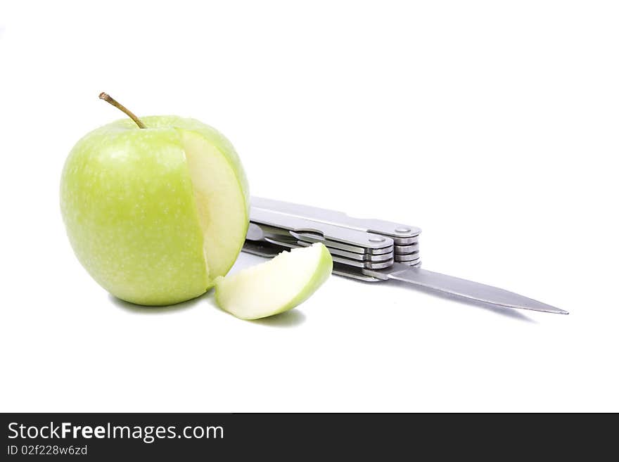 An apple with a segment cut away from it and a locknife isolated on a white background. An apple with a segment cut away from it and a locknife isolated on a white background