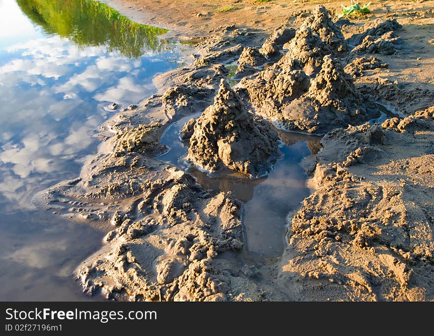 Sand castles and sky in water reflection. Sand castles and sky in water reflection