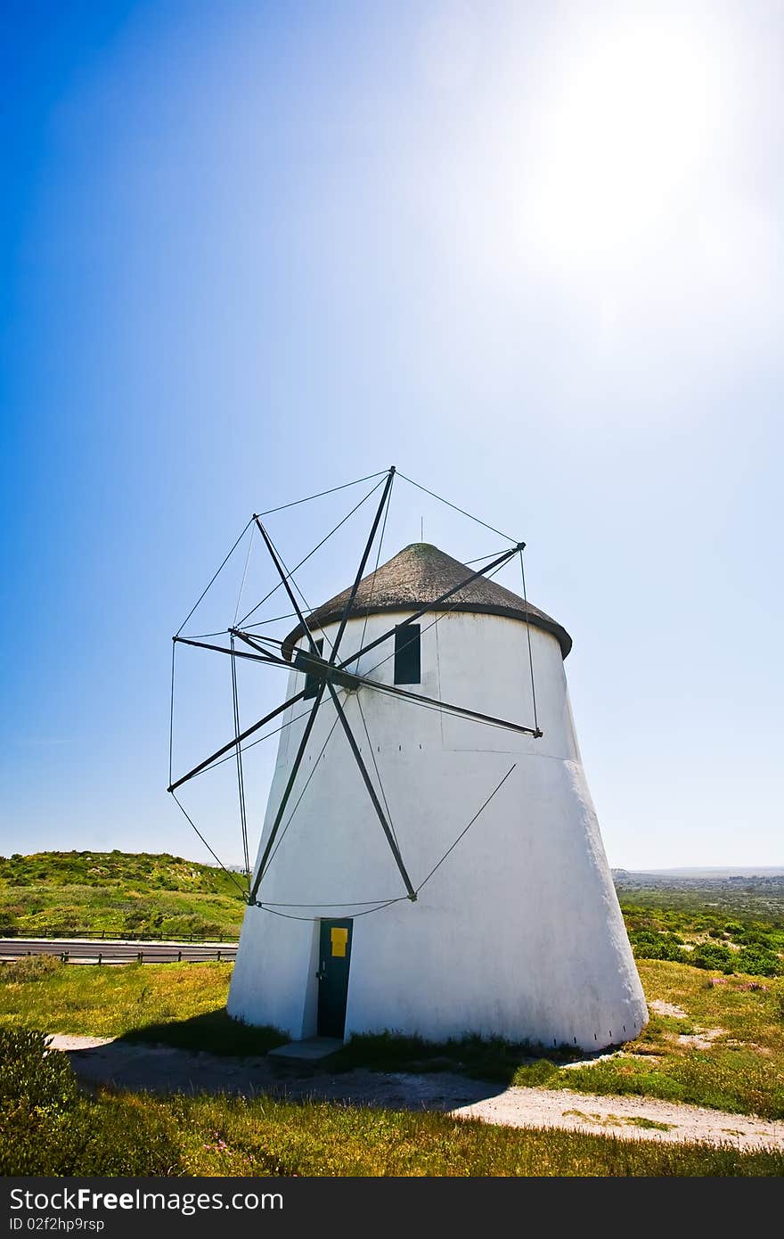 A frontal view of a windmill in action on a sunny day. A frontal view of a windmill in action on a sunny day.