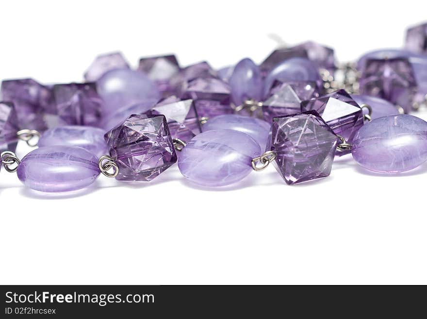 A chain  with purple jewels isolated on white. A chain  with purple jewels isolated on white