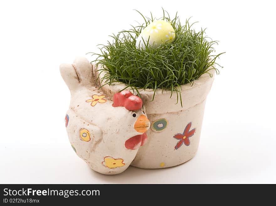 Clay pot in the shape of chicken with grass and egg on the top. Clay pot in the shape of chicken with grass and egg on the top.