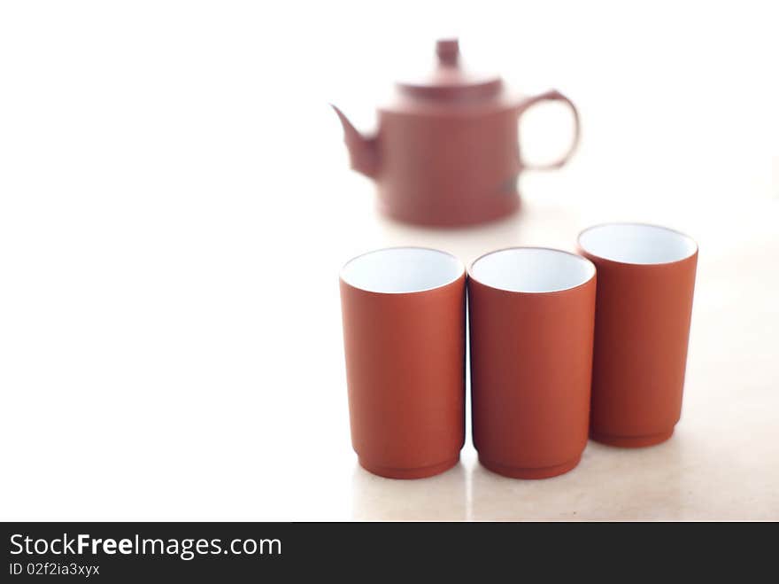 Chinese teapot with teacups set on marble table