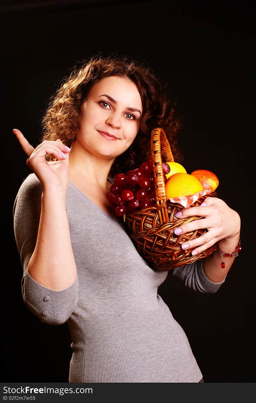 Portrait of young beautiful woman holding fruits in the basket. Portrait of young beautiful woman holding fruits in the basket