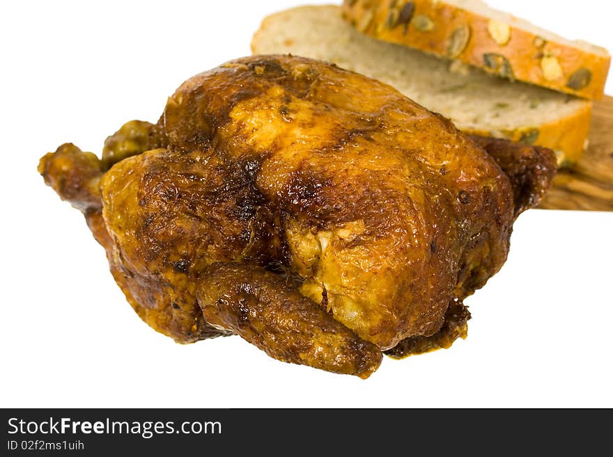 Roasted chicken on white plate isolated on a white background. Roasted chicken on white plate isolated on a white background.