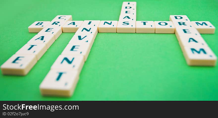 A scrabble game showing the words brainstorm, create, invent, ideas and dream.