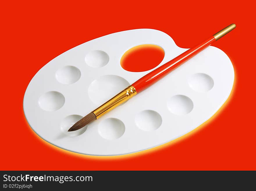 Artist palette and brush isolated on red. Artist palette and brush isolated on red