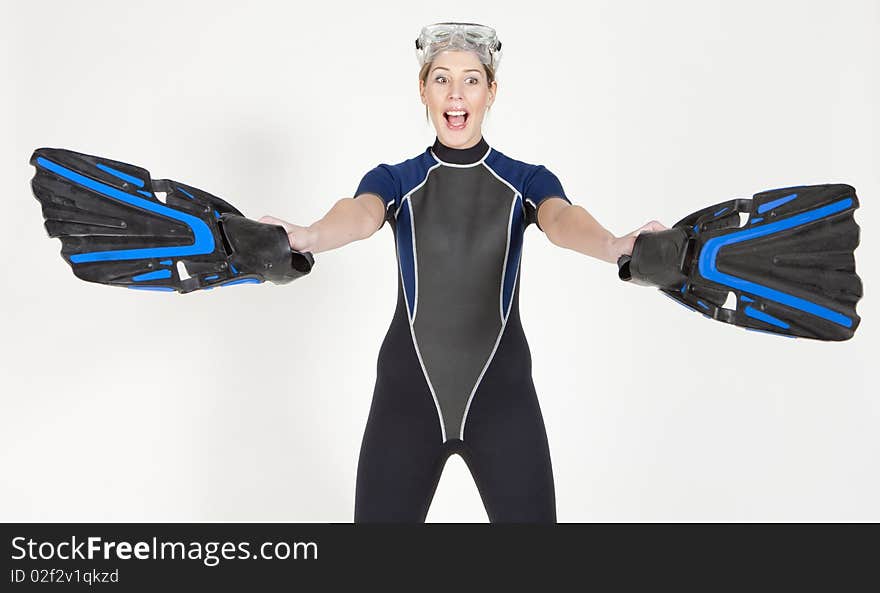 Portrait of woman wearing neoprene with flippers and diving goggles