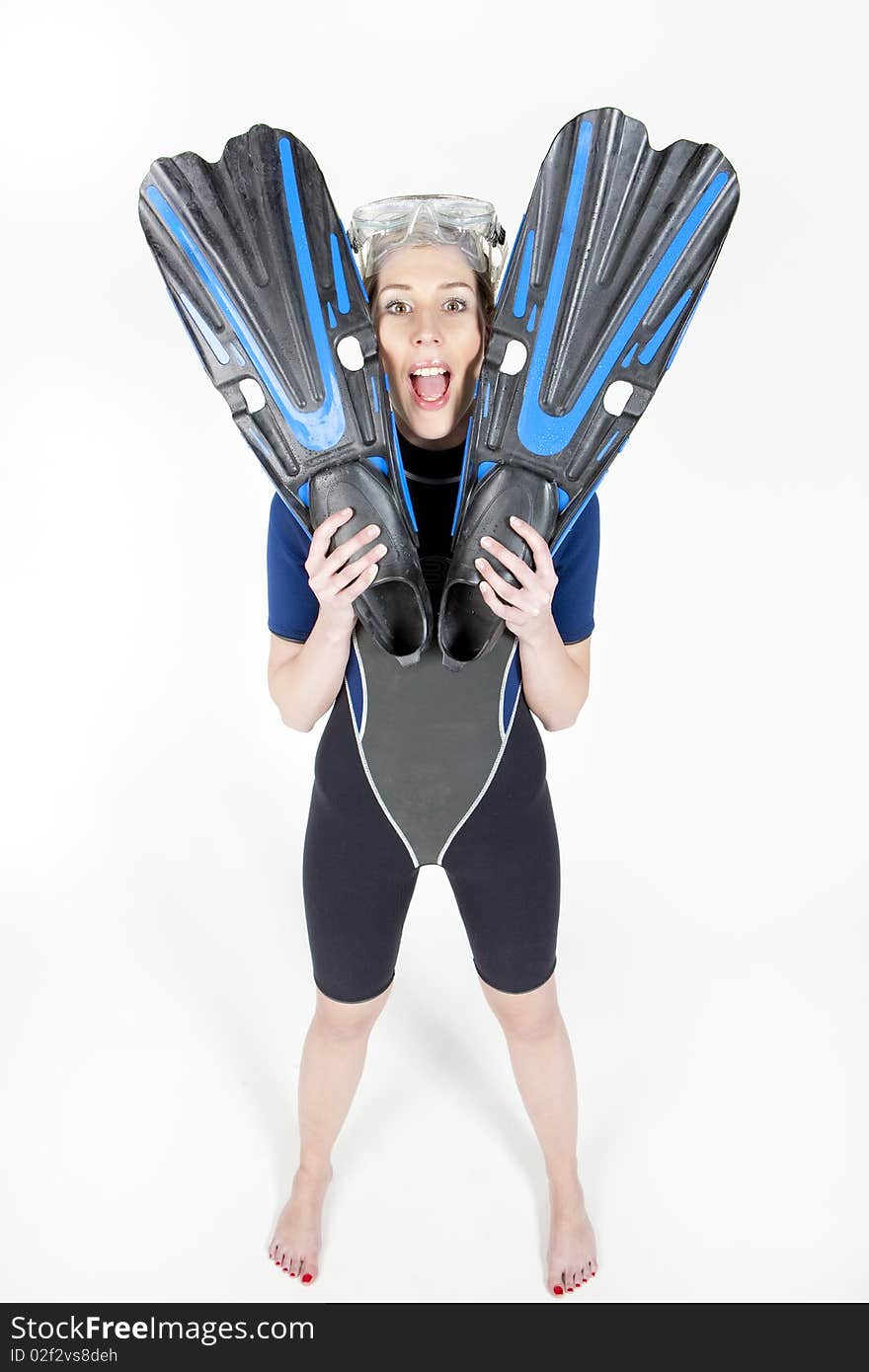 Standing young woman wearing neoprene with flippers and diving goggles. Standing young woman wearing neoprene with flippers and diving goggles