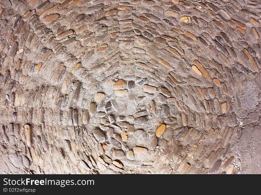 Pavement of pebble in a street of the old quarter - traditional italian paving of city streets