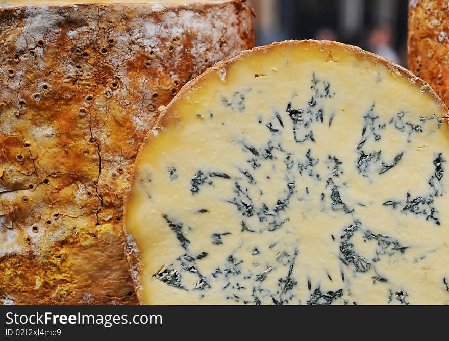 A slice through a cheese wheel showing veins. A slice through a cheese wheel showing veins