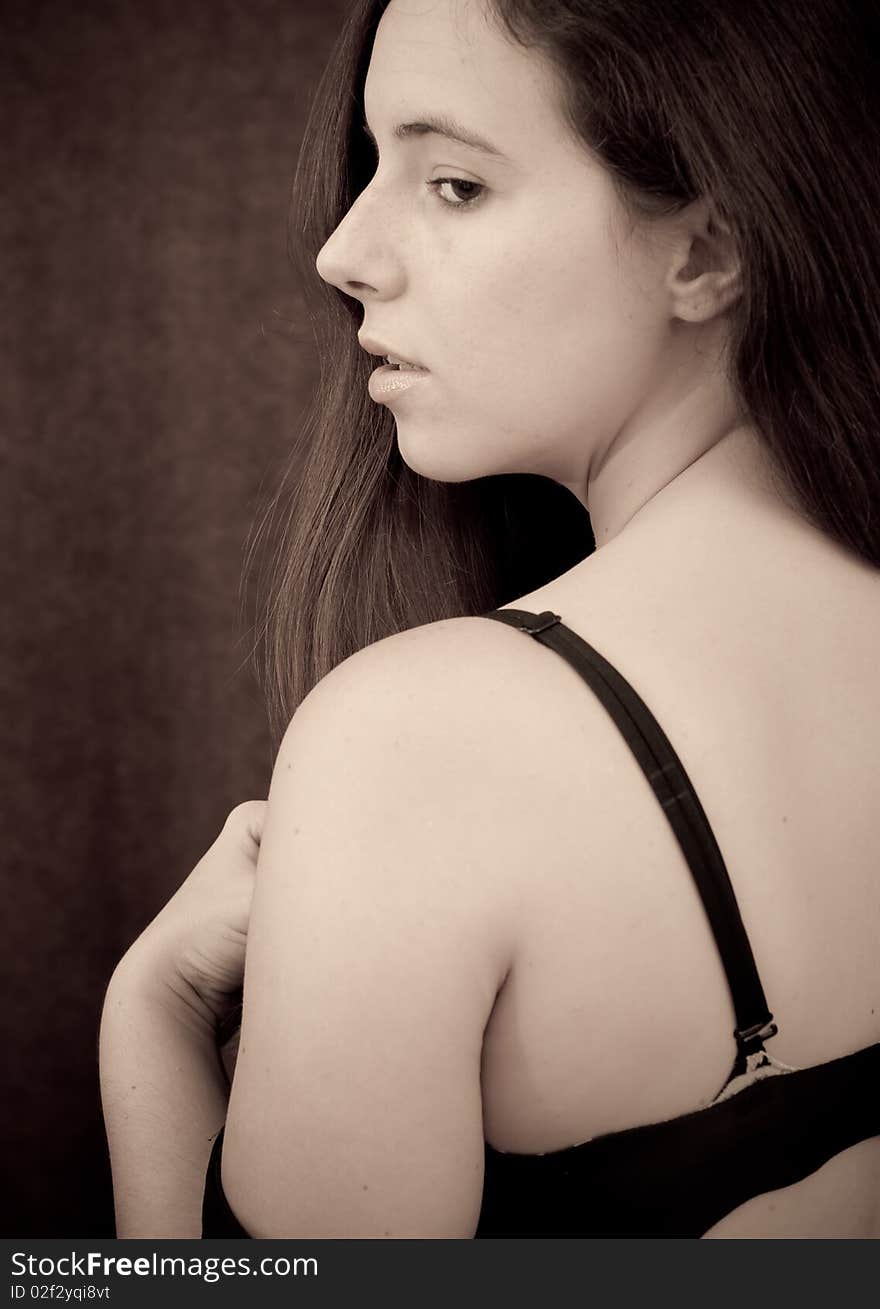 Portrait of a Girl Taking Off Her Dress exposing back and bra with side view of face. Portrait of a Girl Taking Off Her Dress exposing back and bra with side view of face