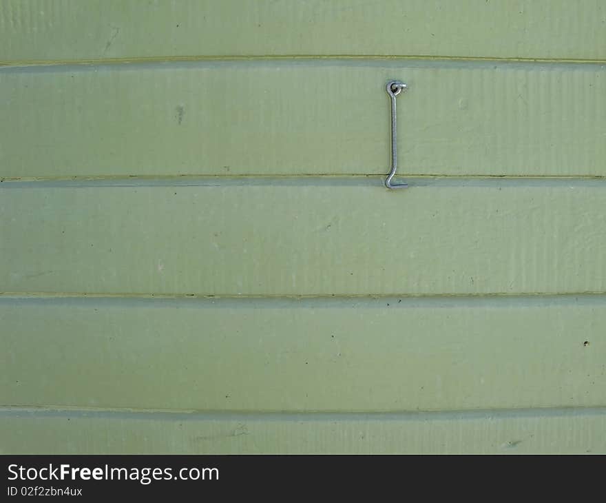 Pale green wooden wall with hasp useful as background. Pale green wooden wall with hasp useful as background.