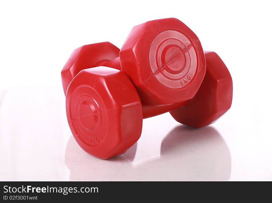 Red dumbbells isolated over white. Red dumbbells isolated over white.