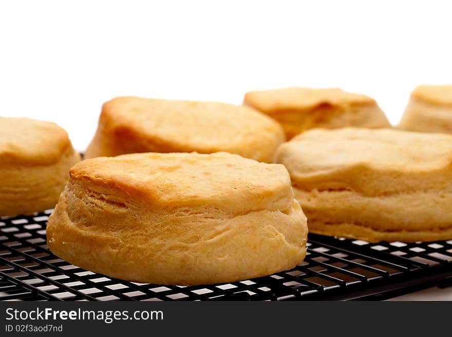 Horizontal close up of fresh baked biscuits on white