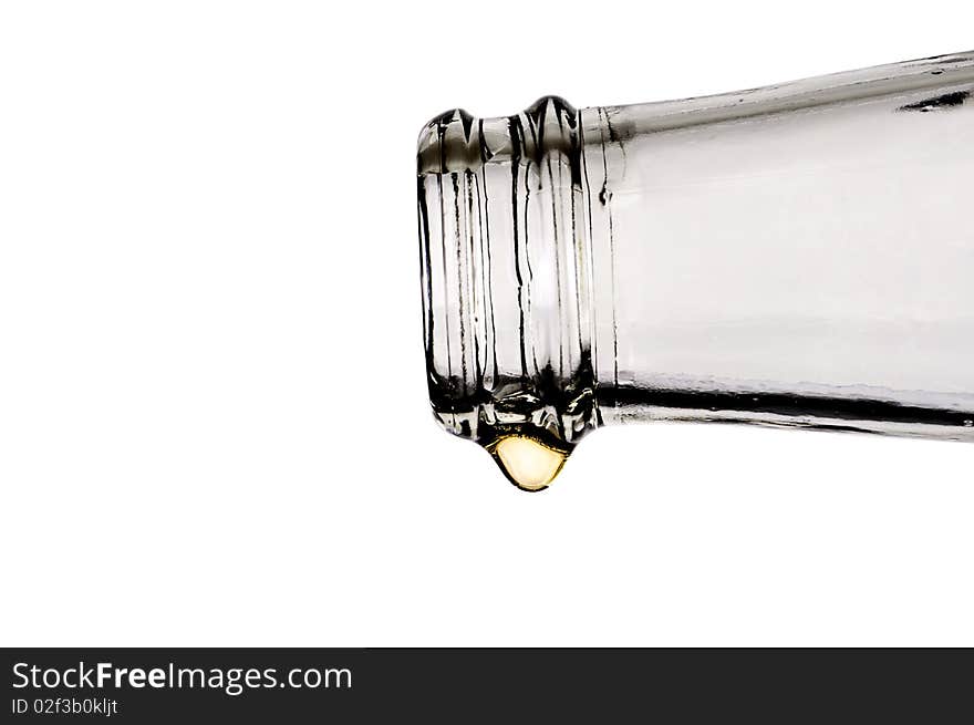 Beer bottle with the last drop of beer on white