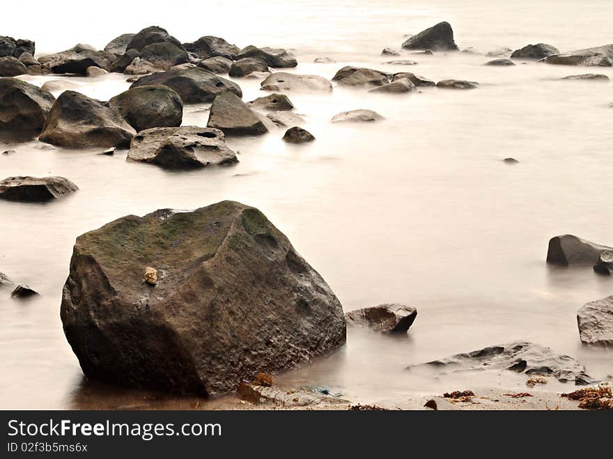 Serene Waters on a Rocky Beach Shore