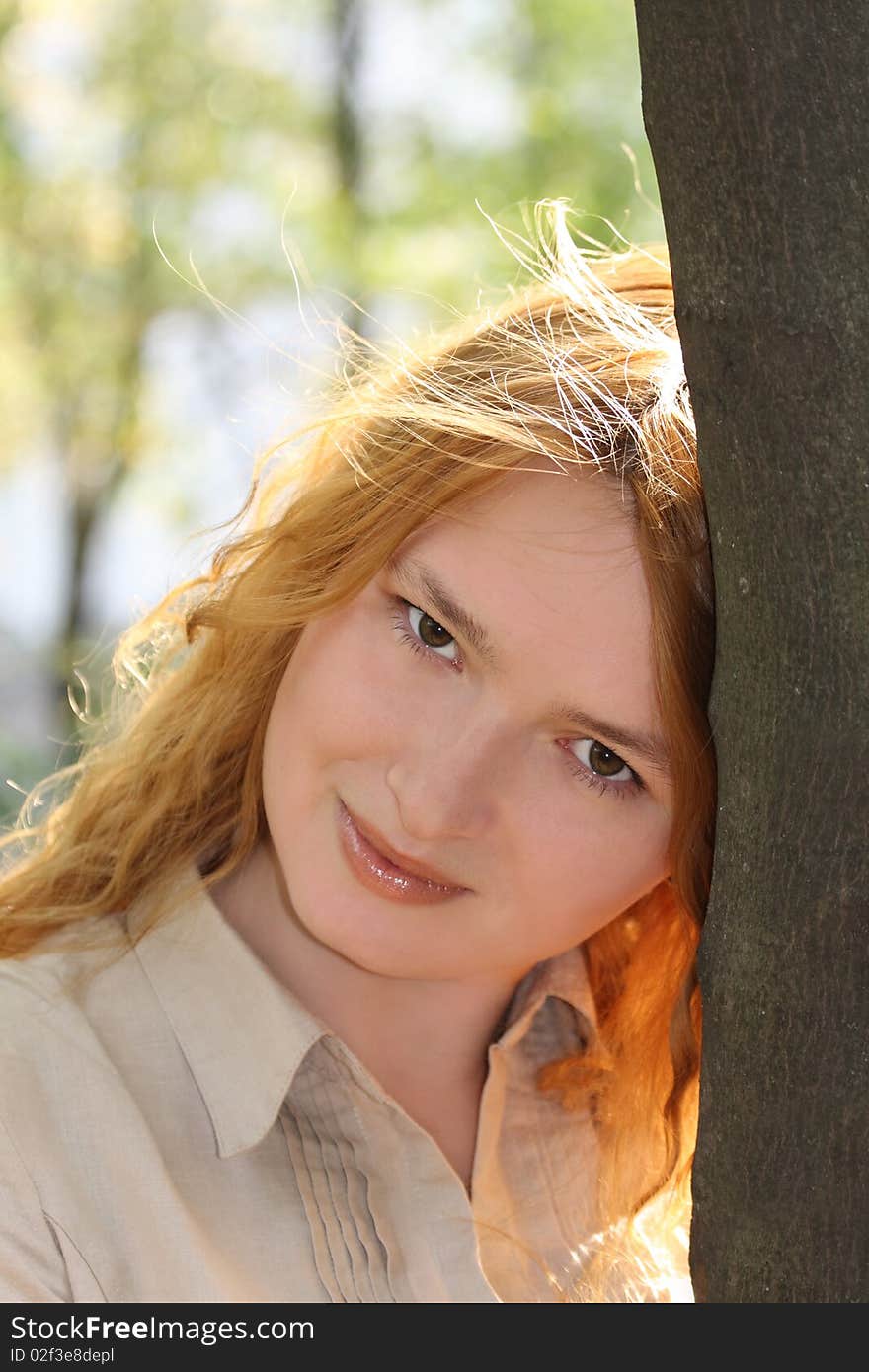 Pretty girl near tree. Spring - Summer portrait