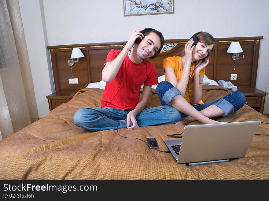 Young  couple with musical ear-phones