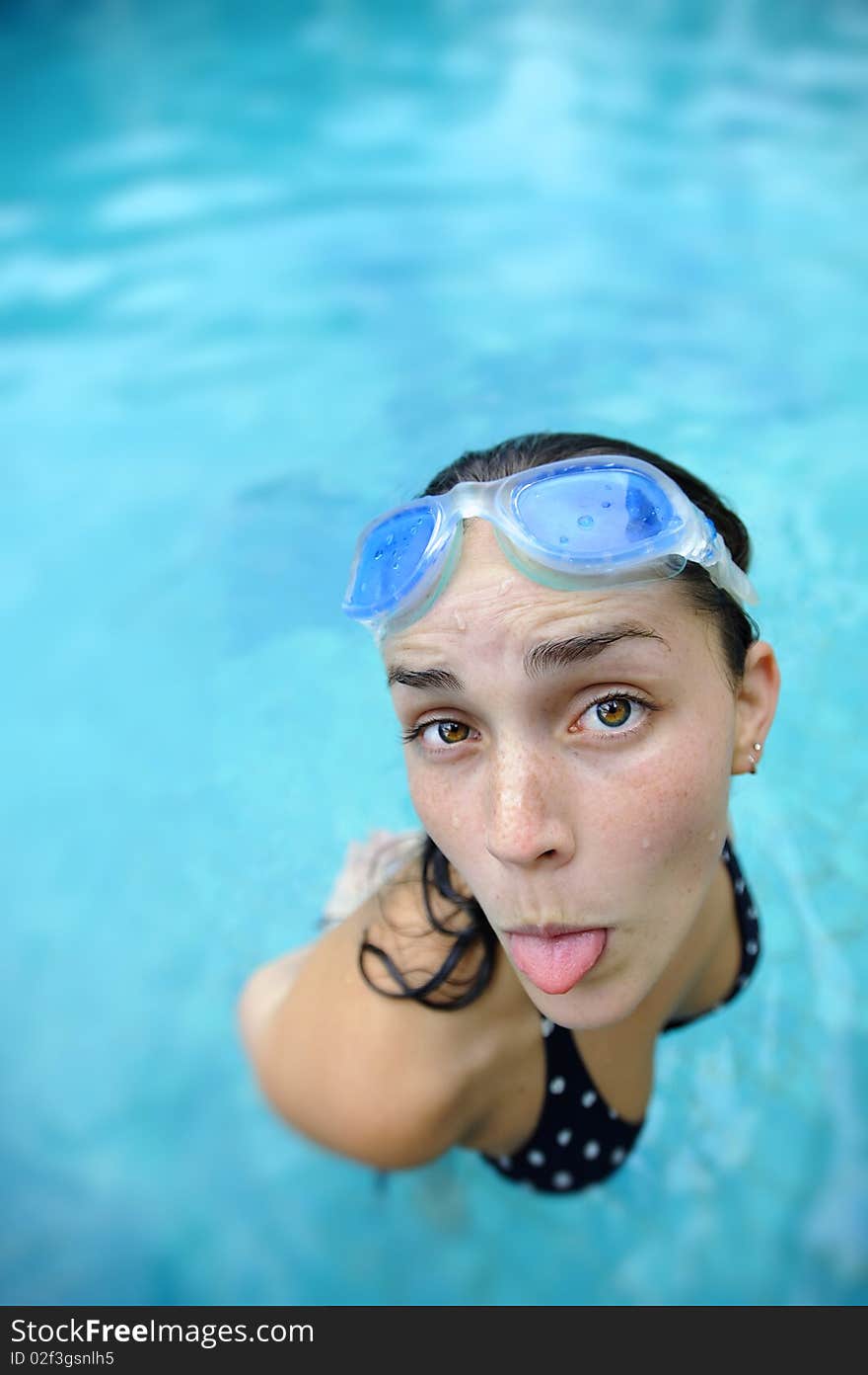 Pretty girl sticks tongue out at the pool. Pretty girl sticks tongue out at the pool