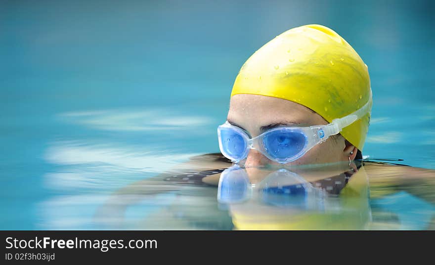 Submerged swimmer looks over the water surface. Submerged swimmer looks over the water surface