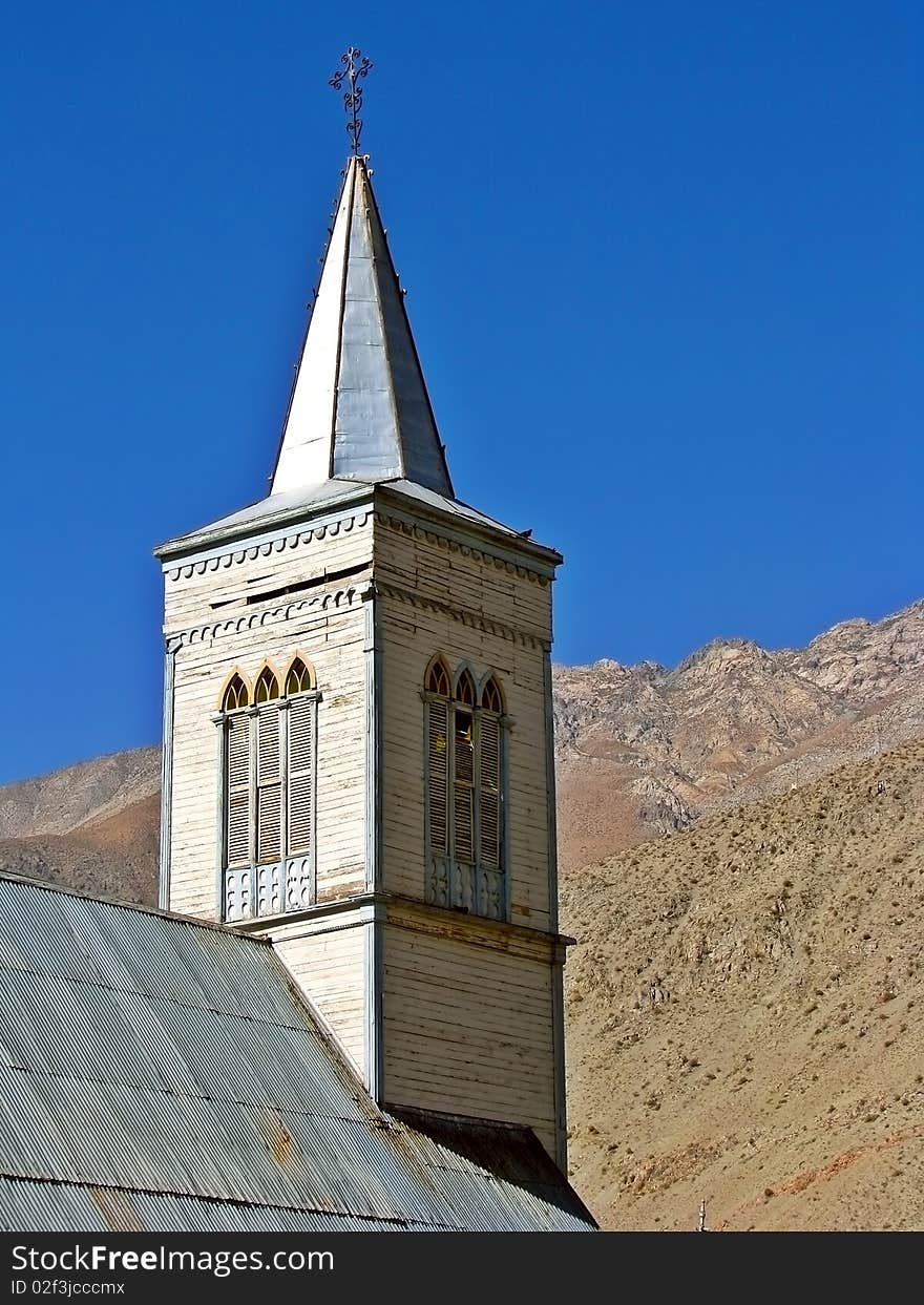 Close up of the bell tower of an ancient church in the mountain.