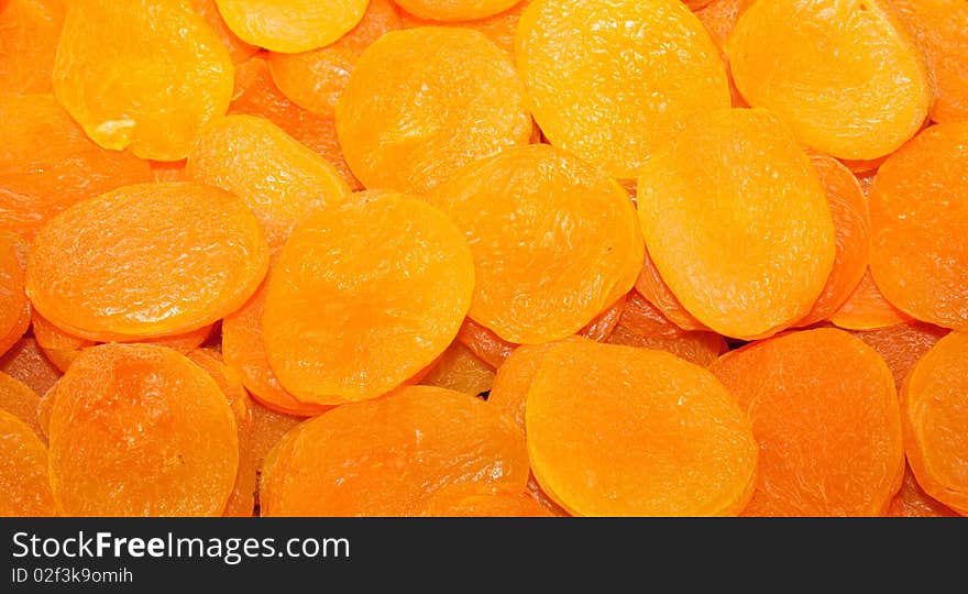 A background of dried yellow and orange apricots. A background of dried yellow and orange apricots