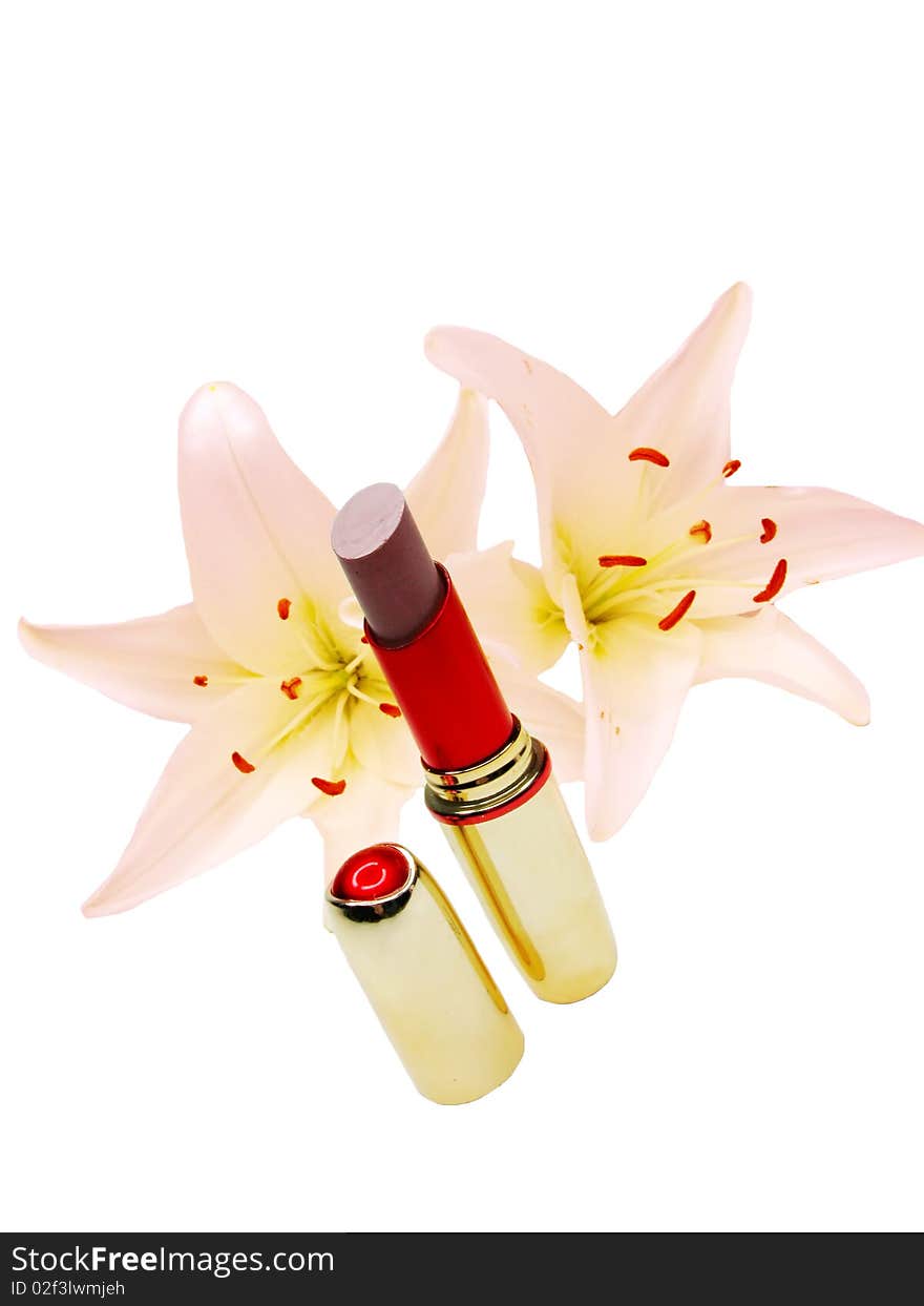 Brown lipstick in red box with pink lilies flowers on white background. Brown lipstick in red box with pink lilies flowers on white background