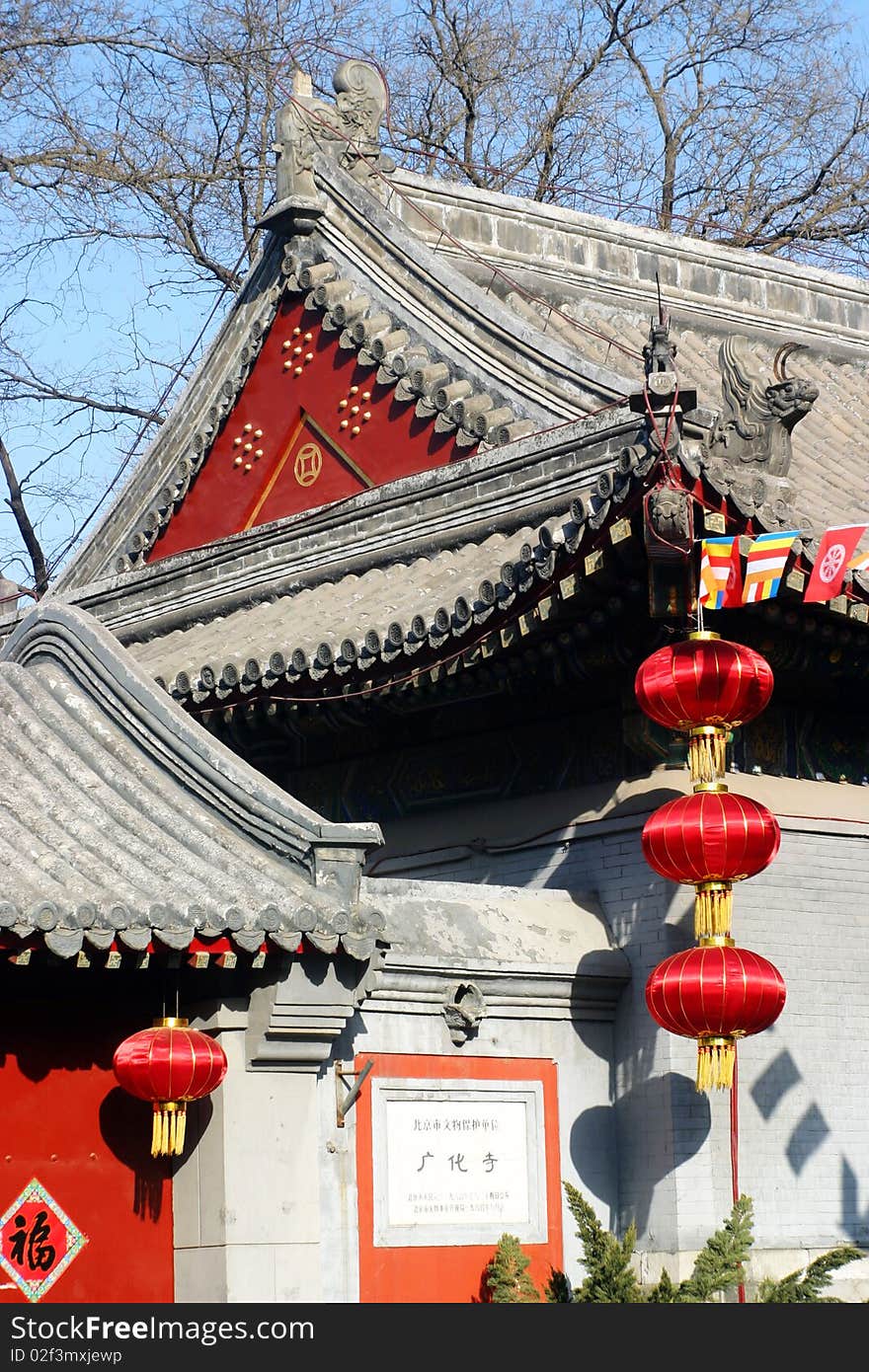 Red lanterns and temple roof of an old buddhist temple in beijing,china