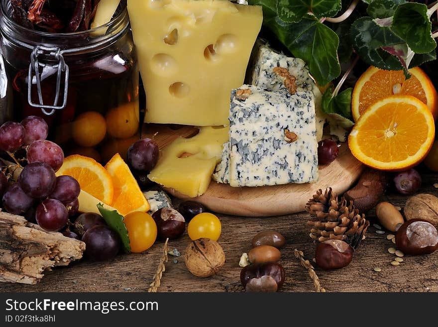 Closeup with fruits, vegetables traditional cheese studio isolated and plants around