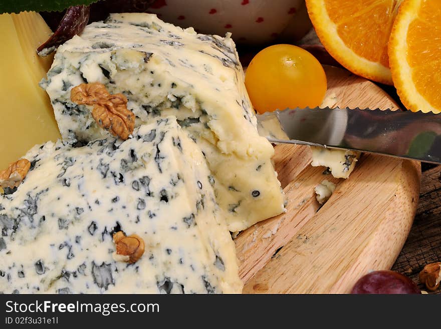 Closeup with fruits, vegetables traditional cheese studio isolated and plants around