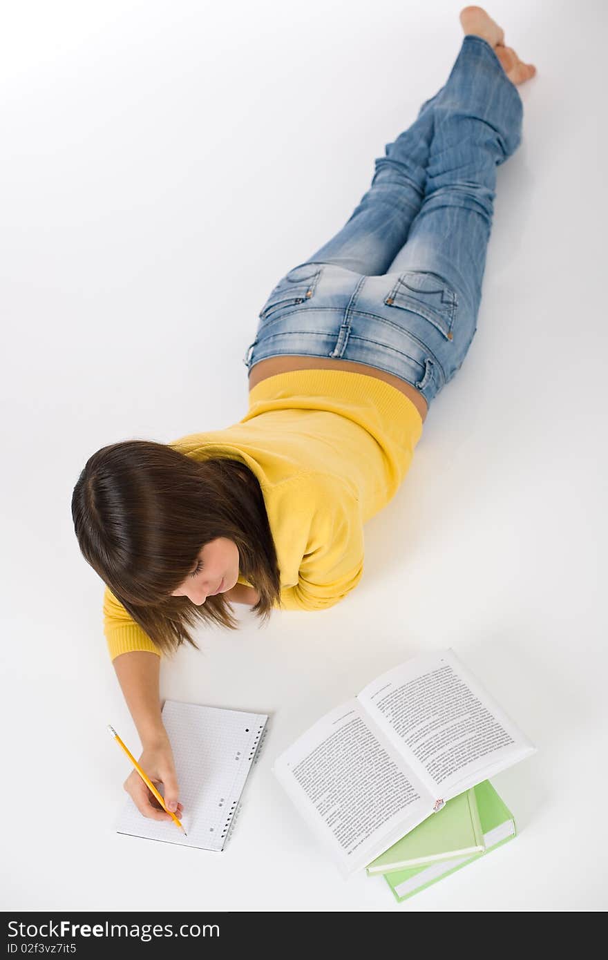 Student - female teenager write homework with book on white background