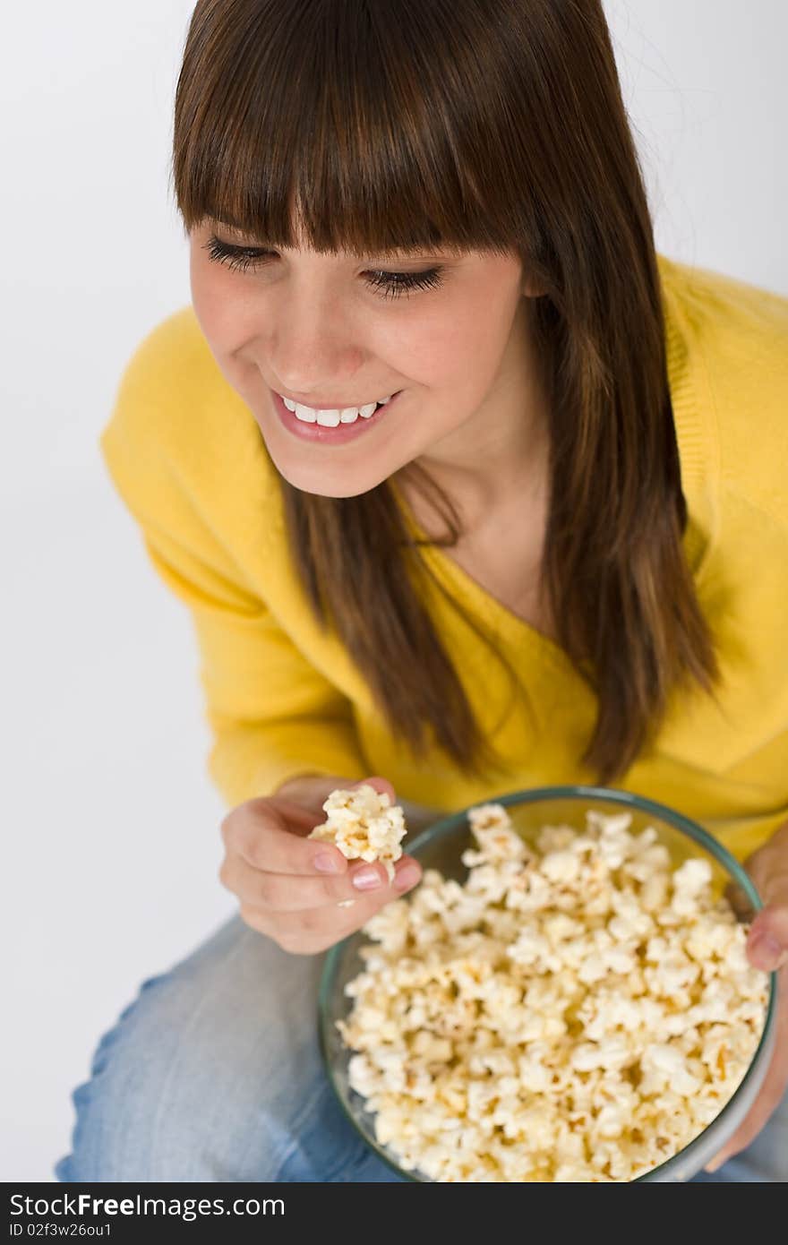 Smiling female teenager with popcorn