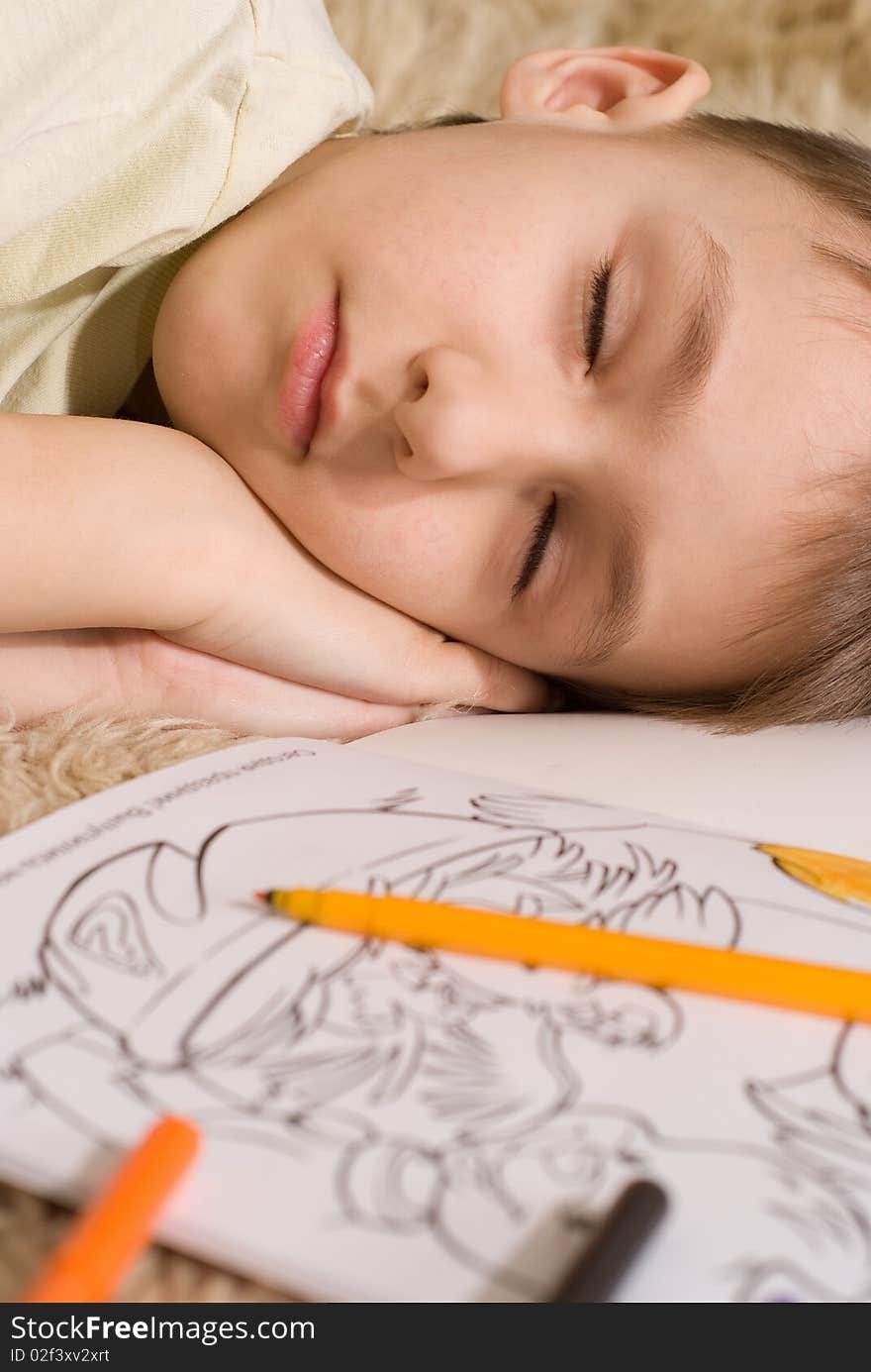 Boy Lying Asleep On The Carpet