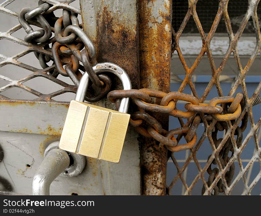 Close up shot of a chained metal rusty door. Close up shot of a chained metal rusty door.