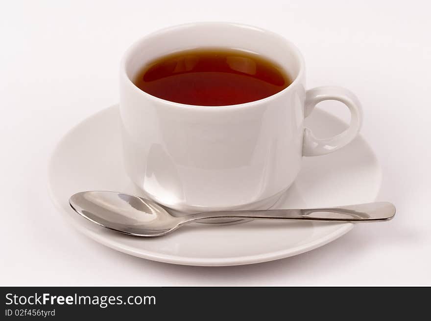 Little white tea cup isolated over grey gradient background