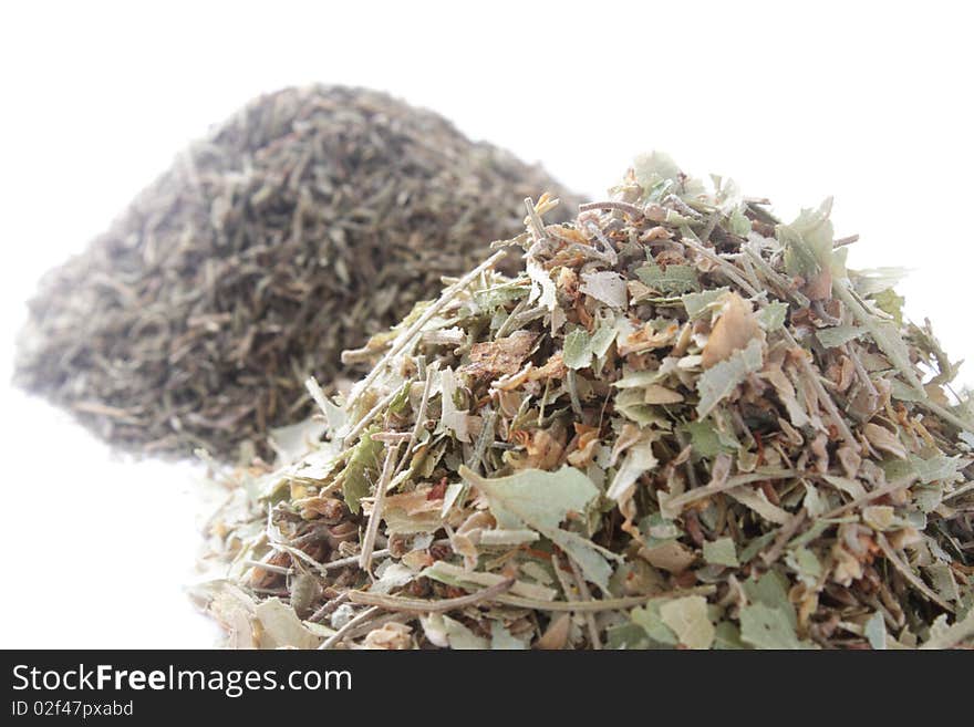 Two piles of herbs on white background