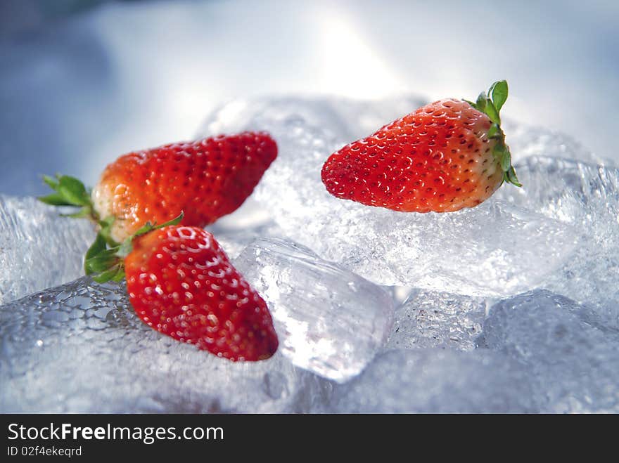 Three strawberries on ice