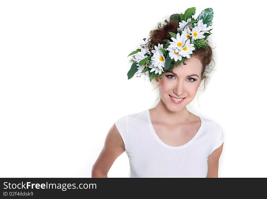 Young beautiful woman in floral wreath over white