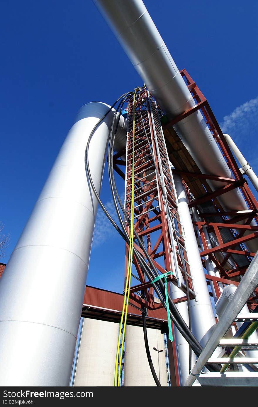 Industrial pipelines against blue sky