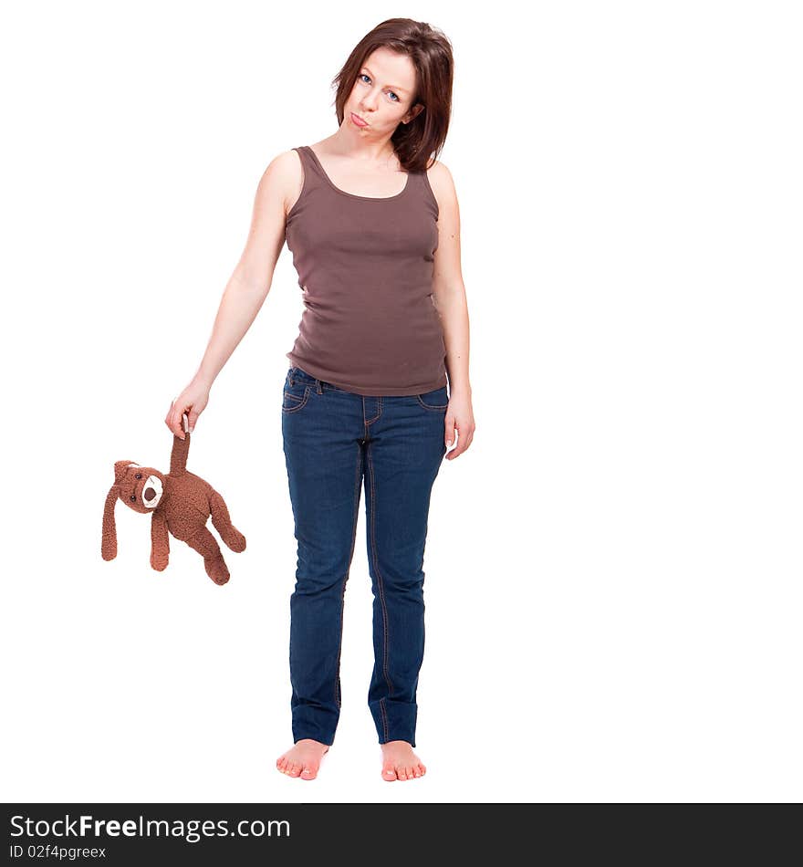 Young lonely pregnant woman with a toy rabbit looking very sad. Young lonely pregnant woman with a toy rabbit looking very sad.