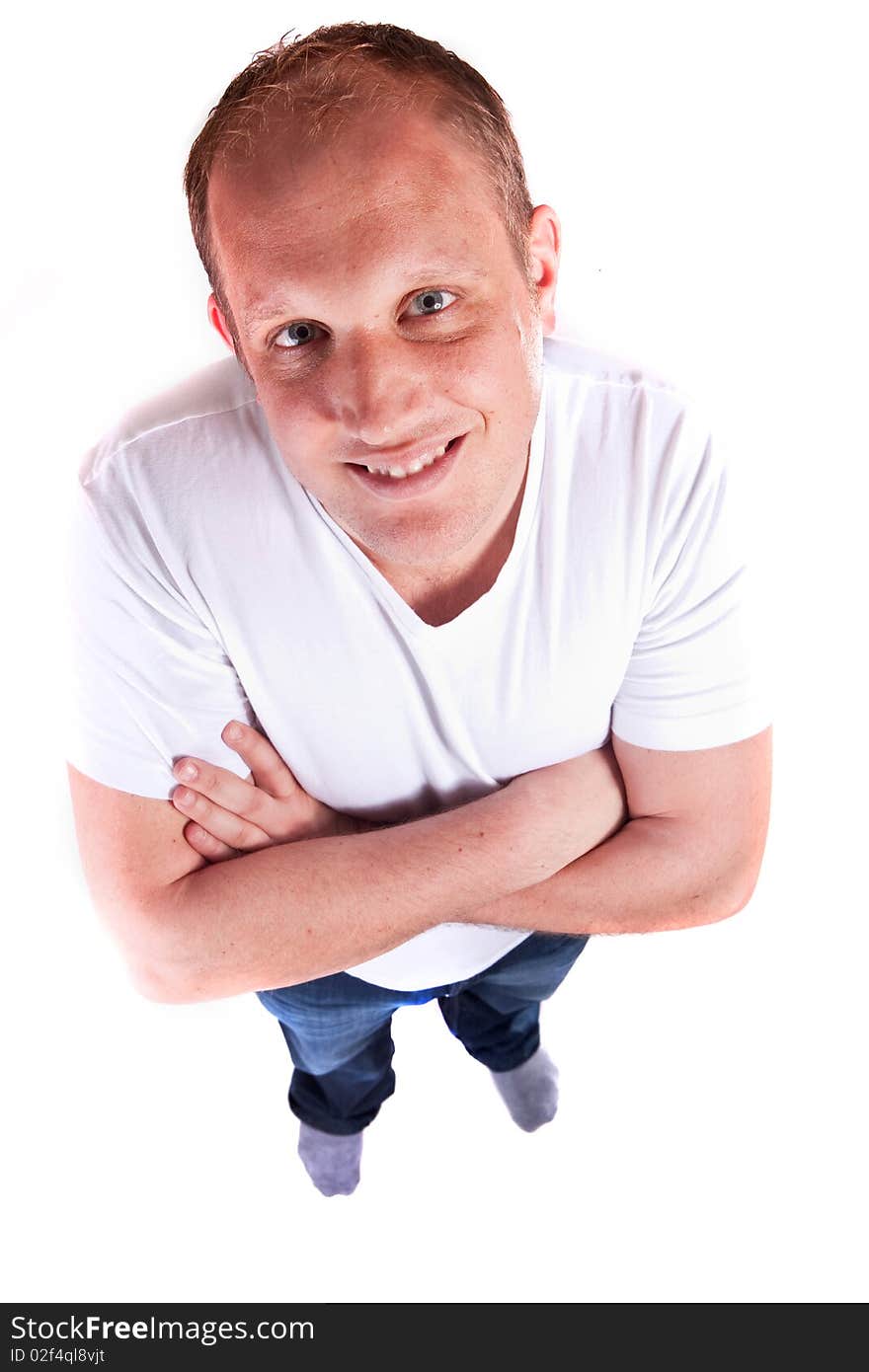 Young confident blond man looking in the camera situated above. Young confident blond man looking in the camera situated above